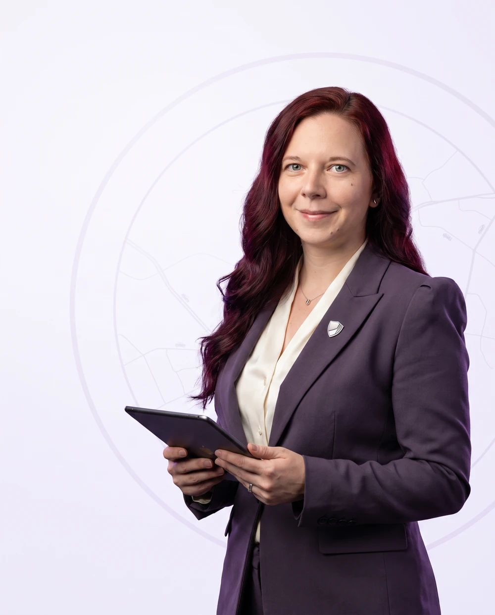 AI-assisted campaign portrait of Kailie Green in a plum suit, holding a tablet.