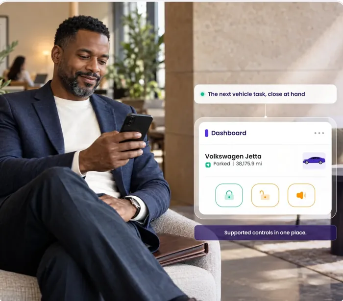A man in a lounge chair; the Dashboard card shows lock, unlock and horn controls for a Volkswagen Jetta.