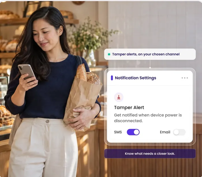 A woman in a bakery checking her phone; the Notification Settings card shows Tamper Alert turned on.